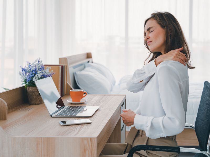 women with neck pain while sitting on office chair